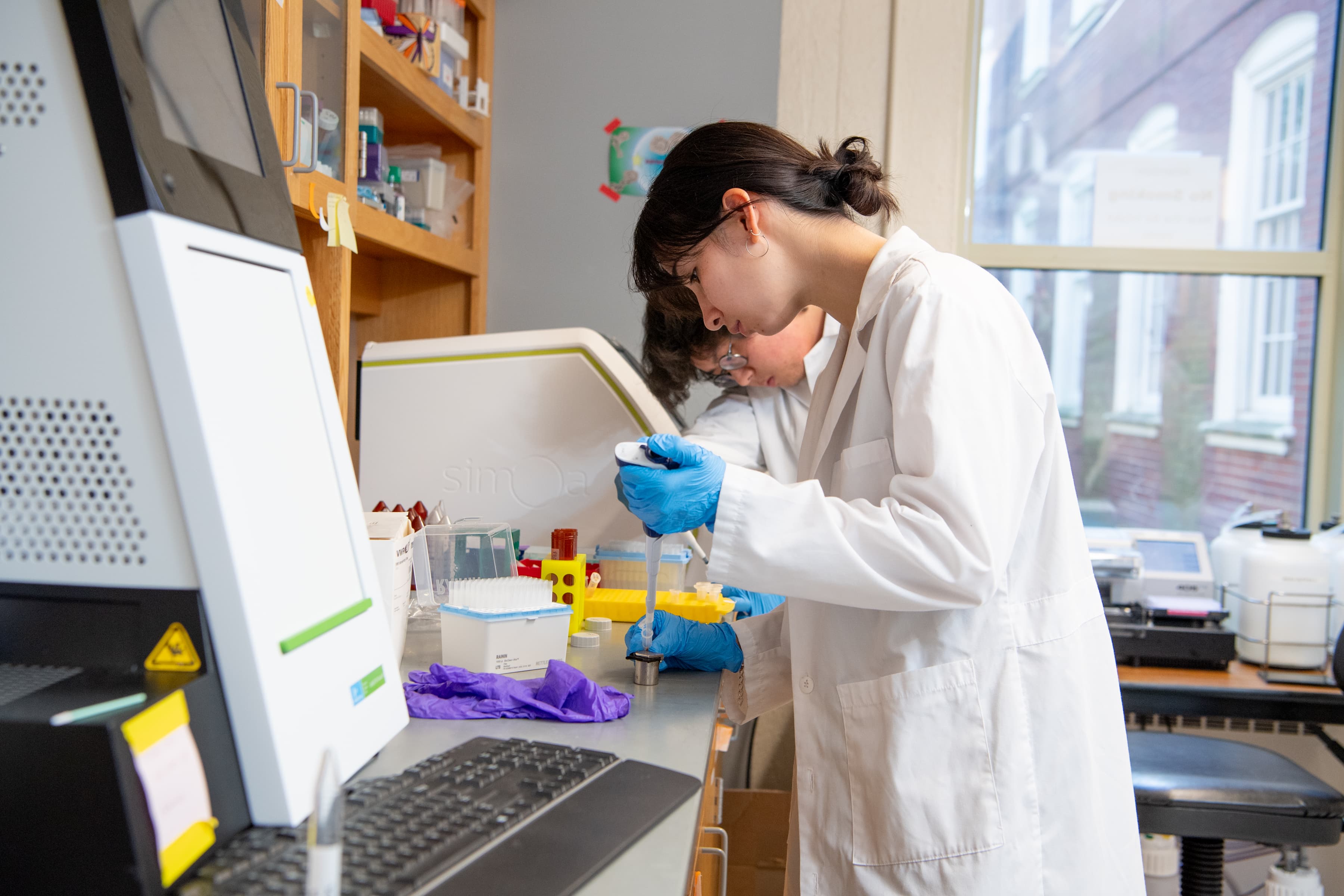 Tripathi Lab researchers preparing samples at the bench